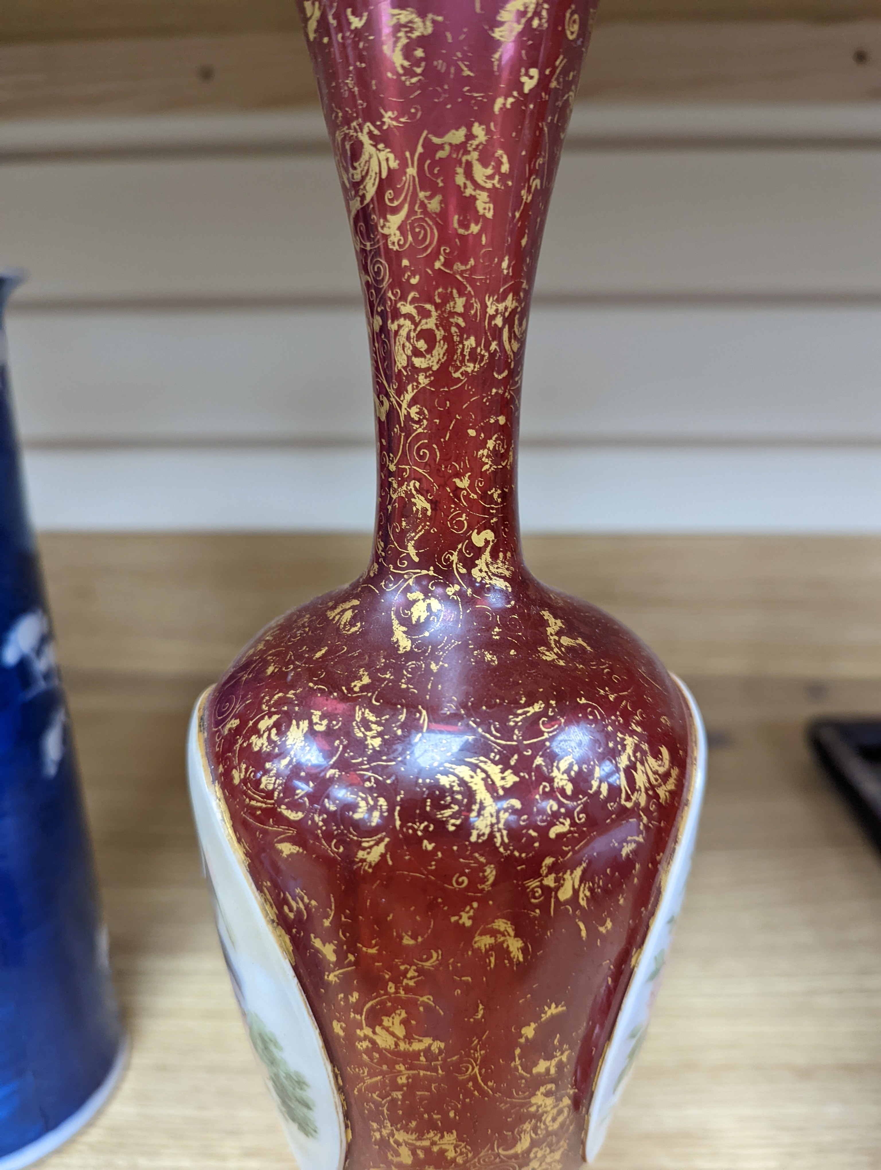 A pair of 19th century Bohemian enamelled and overlaid ruby glass vases 36cm